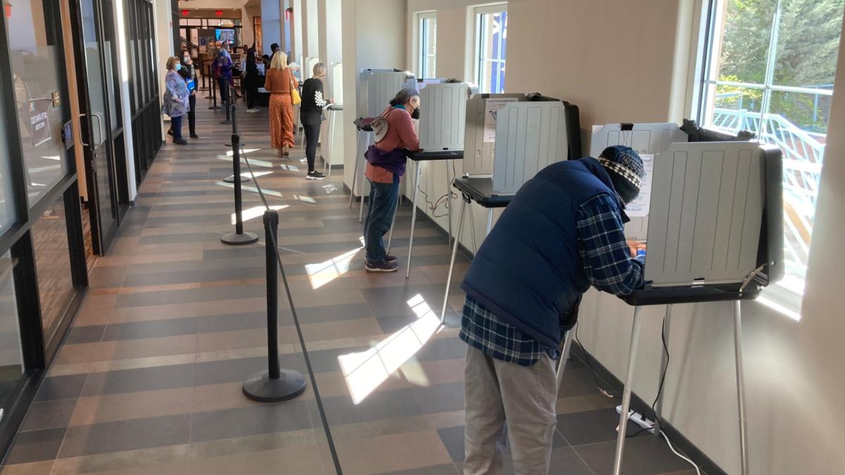 Santa Fe County, N.M., residents fill out general election ballots during the first day of general election voting, Oct. 11, 2022, in a hallway outside the Santa Fe County Clerk's Office in Santa Fe, N.M. (AP Photo / Morgan Lee, File)