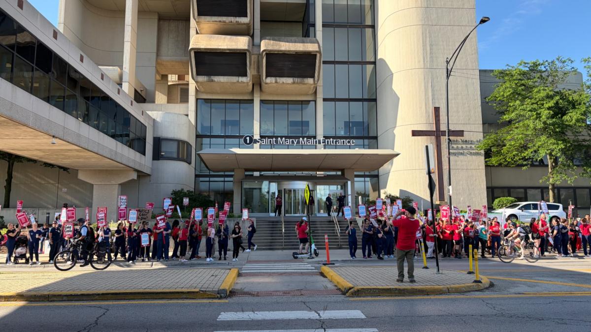 Nurses and supporters rallied outside Saint Mary of Nazareth Hospital on June 11, 2026, in a planned one-day strike to protest nurse firings and alleged union busting from hospital management. (Eunice Alpasan / WTTW News)