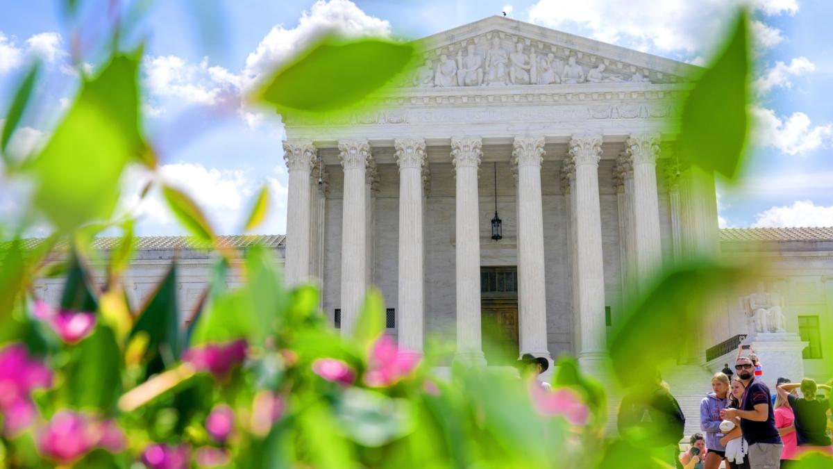 Visitors walk in front of the Supreme Court Friday, July 24, 2026, in Washington. (AP Photo / Mariam Zuhaib)