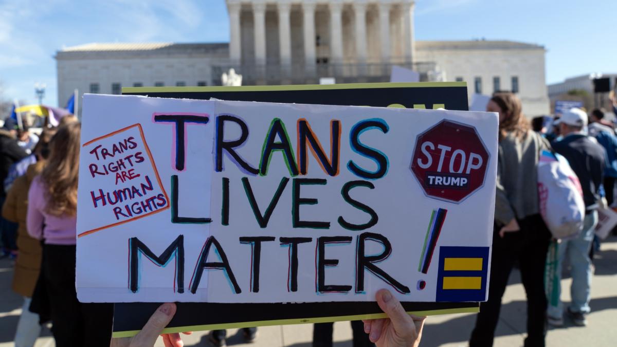 Protesters gather outside the Supreme Court as it hears arguments over state laws barring transgender girls and women from playing on school athletic teams, Tuesday, Jan. 13, 2026, in Washington. (AP Photo / Jose Luis Magana)