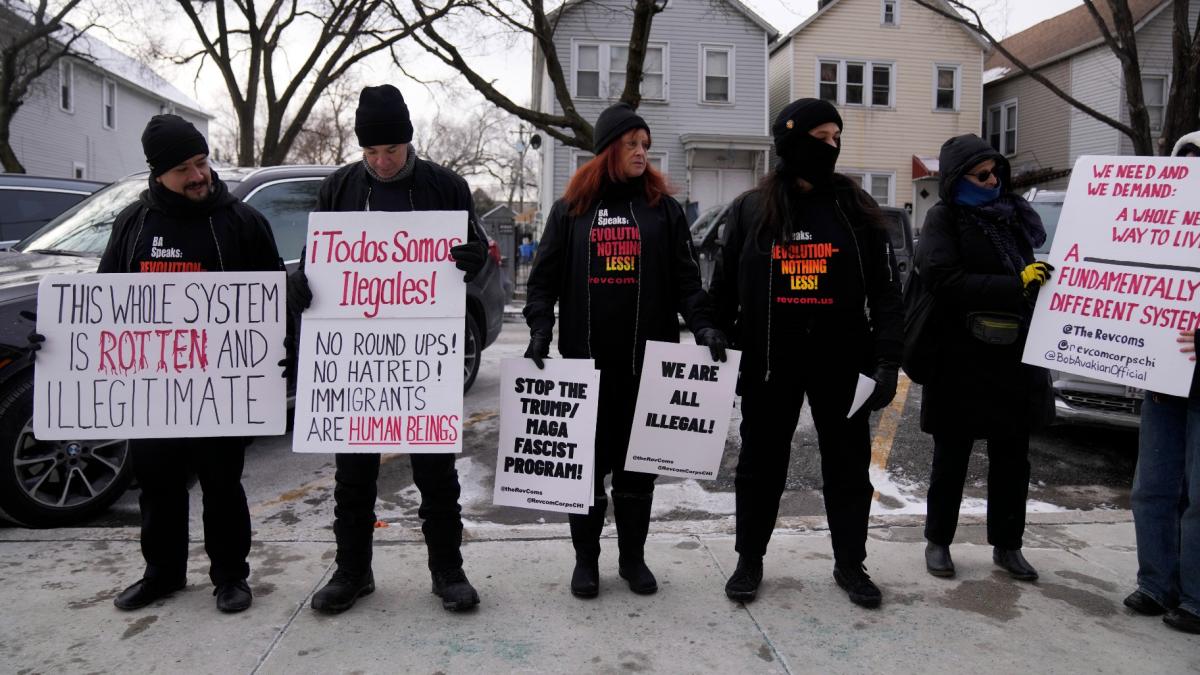 Activists with Revcom Corps Chicago hold signs outside of Hamline Elementary School after federal agents were turned away on Jan. 24, 2025, in Chicago. (AP Photo / Erin Hooley, file)