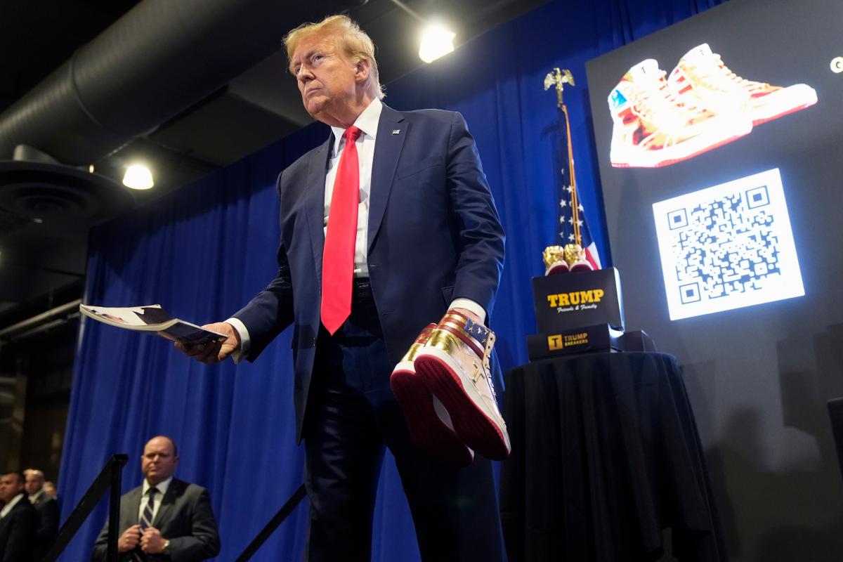 Donald Trump hold a Playboy magazine and gold Trump sneakers at Sneaker Con Philadelphia, an event popular among sneaker collectors, in Philadelphia, Saturday, Feb. 17, 2024. (AP Photo/Manuel Balce Ceneta, File)