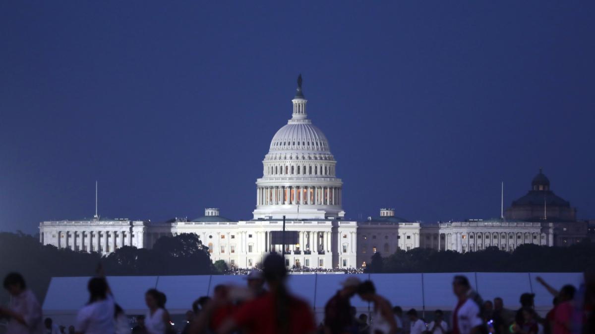 The U.S. Capitol building stands as people wait to watch fireworks near the Washington Monument during Fourth of July celebrations, in Washington, Friday, July 4, 2025. (AP Photo / Rahmat Gul)