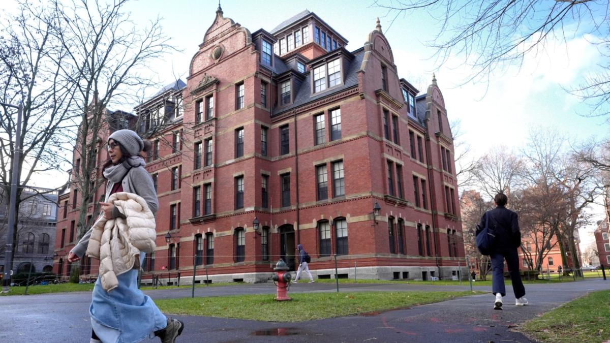FILE - People walk between buildings on Harvard University campus, Dec. 17, 2024, in Cambridge, Mass. (AP Photo / Steven Senne, File)