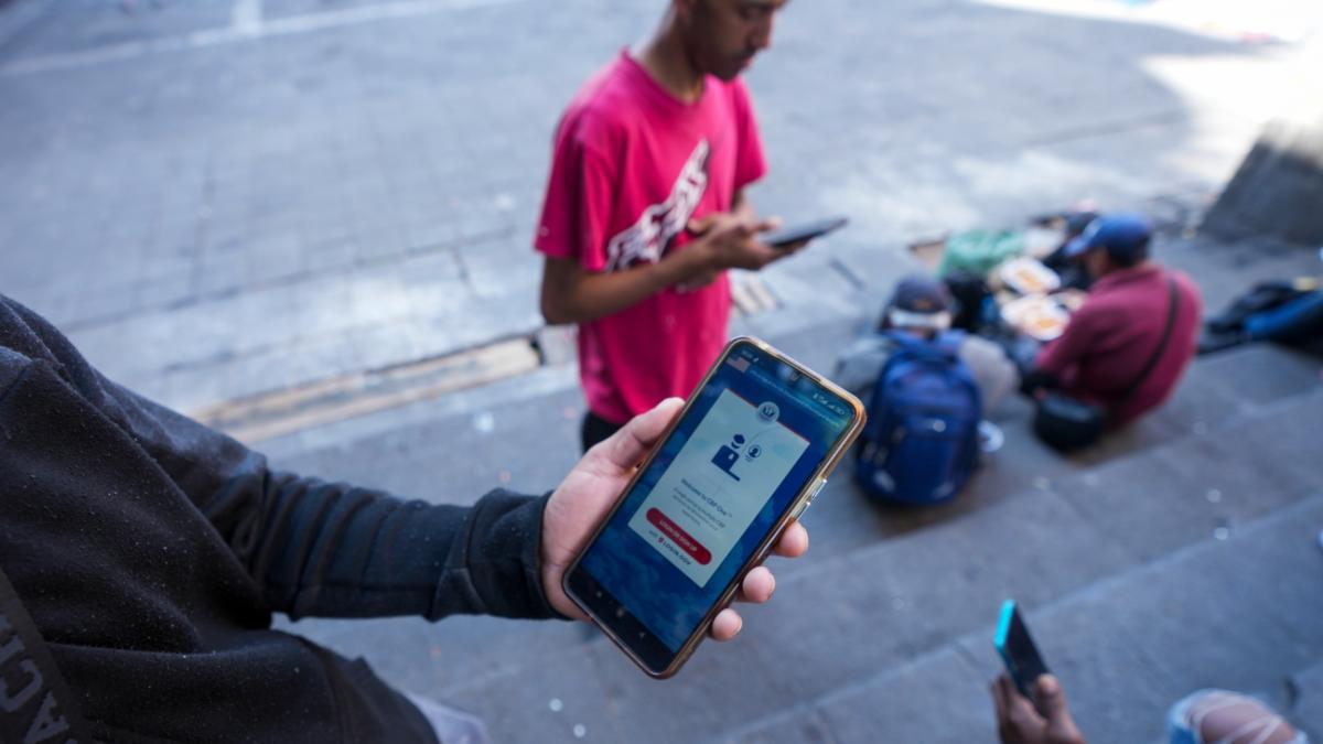 Venezuelan migrant Yender Romero shows the U.S. Customs and Border Protection (CBP) One app on his cell phone, which he said he used to apply for asylum in the U.S. and is waiting on an answer, at a migrant tent camp outside La Soledad church in Mexico City, Monday, Jan. 20, 2025, the inauguration day of U.S. President Donald Trump. (AP Photo / Fernando Llano, File)