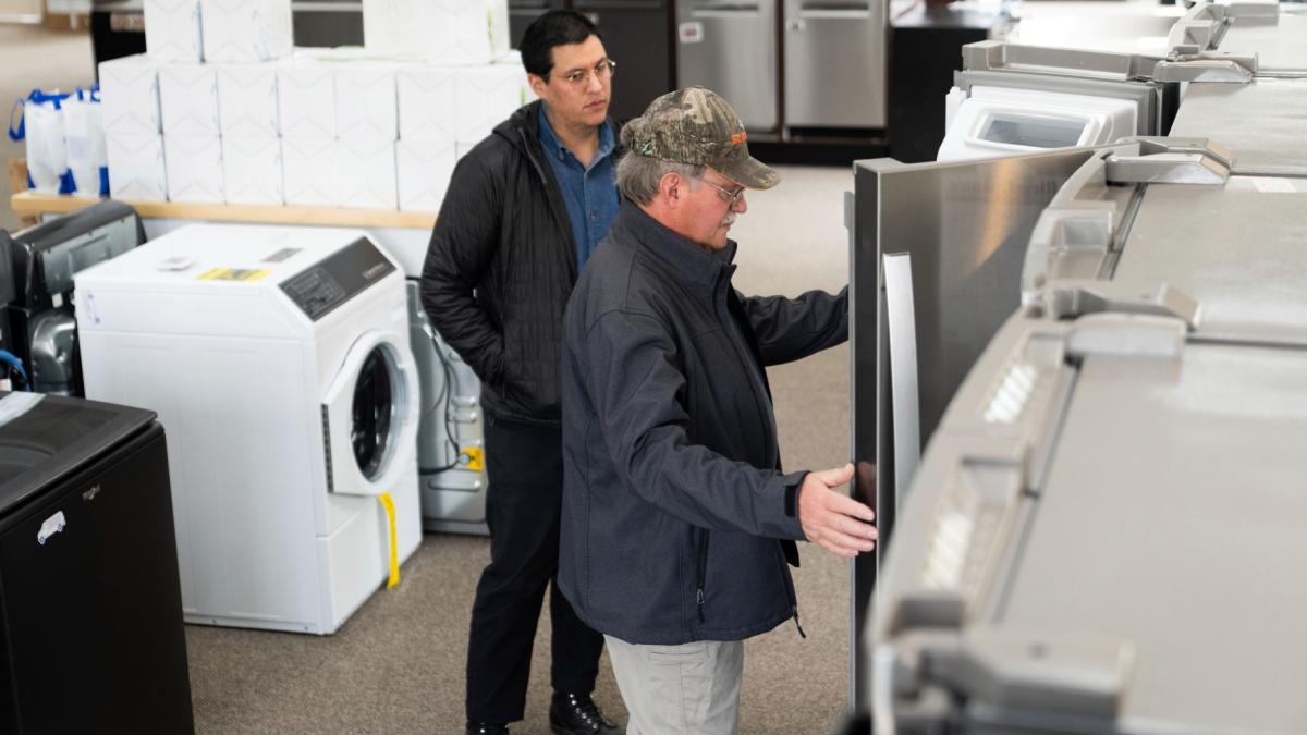 Riegelmann's Appliance employee Noah Guillen helps Dave Scherer, right, as he shops for a refrigerator, in Gresham, Ore., Thursday, April 3, 2025. (AP Photo / Jenny Kane)