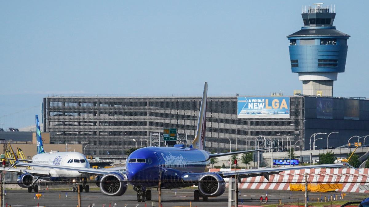 FILE - LaGuardia Airport's air traffic control tower, right, is shown as planes line-up for take-off, Thursday May 25, 2023, in New York. (AP Photo / Bebeto Matthews)