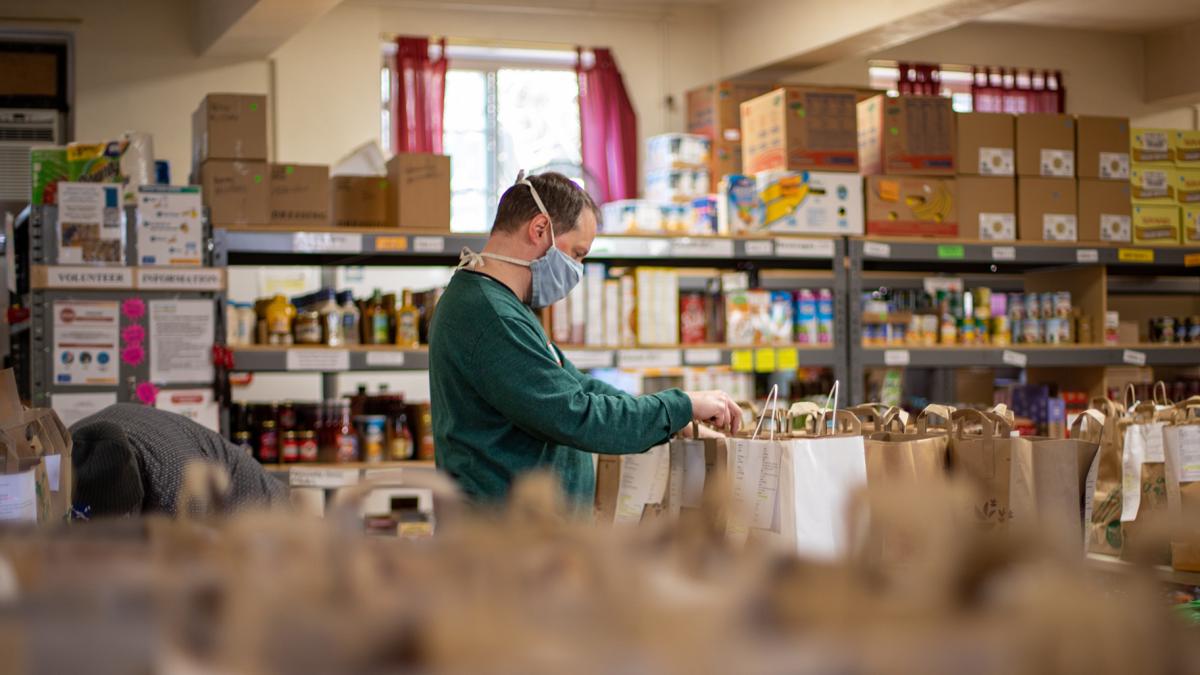 Man works in a food pantry in a file photo. (Photo by Aaron Doucett on Unsplash)