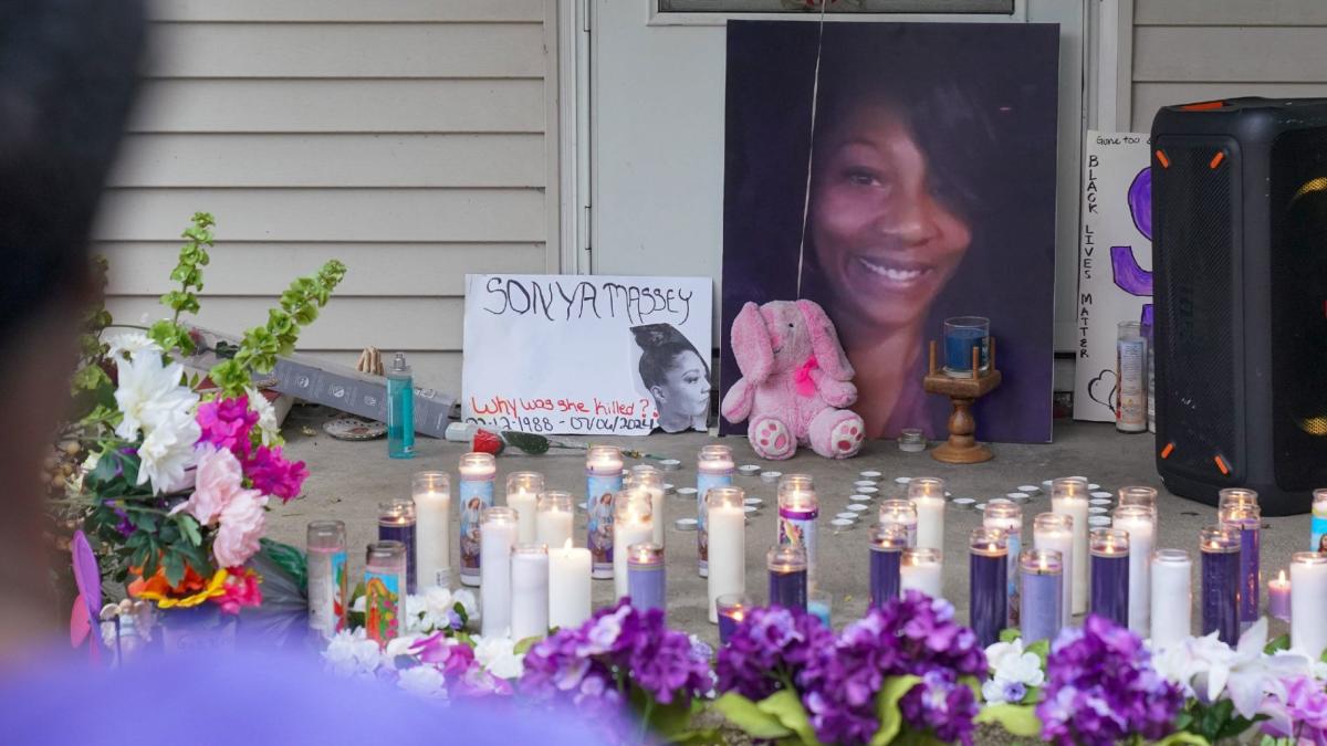 A photo of Sonya Massey, flowers and candles were displayed on the front porch of her home after her death last year. (Trevor Hughes / USA Today Network via CNN Newsource)