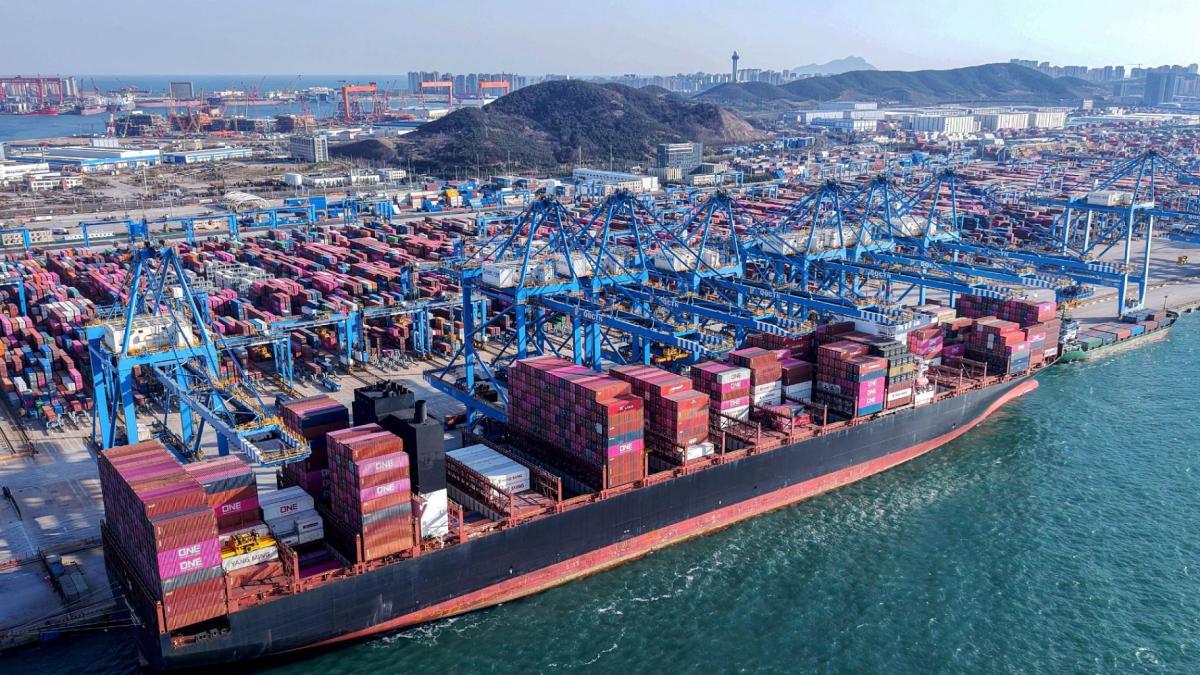 Cranes unload shipping containers from a ship at a port in Qingdao, in eastern China’s Shandong province. (AFP via Getty Images via CNN Newsource)