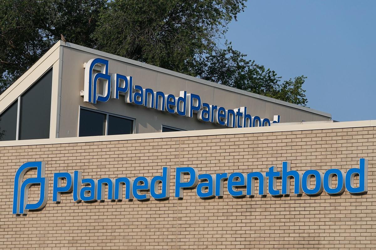 A Planned Parenthood sign is displayed on the outside of the clinic in Indianapolis in August 2023. Planned Parenthood is suing the Trump administration over the “big beautiful bill.” (Darron Cummings / AP / File via CNN Newsource)