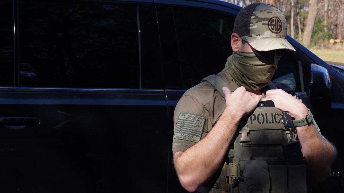 A Department of Homeland Security Investigations Officer searches for two people who fled the scene after being stopped while selling flowers on the side of the road Nov. 16, 2025, in Charlotte, North Carolina. (Ryan Murphy / Getty Images via CNN Newsource)