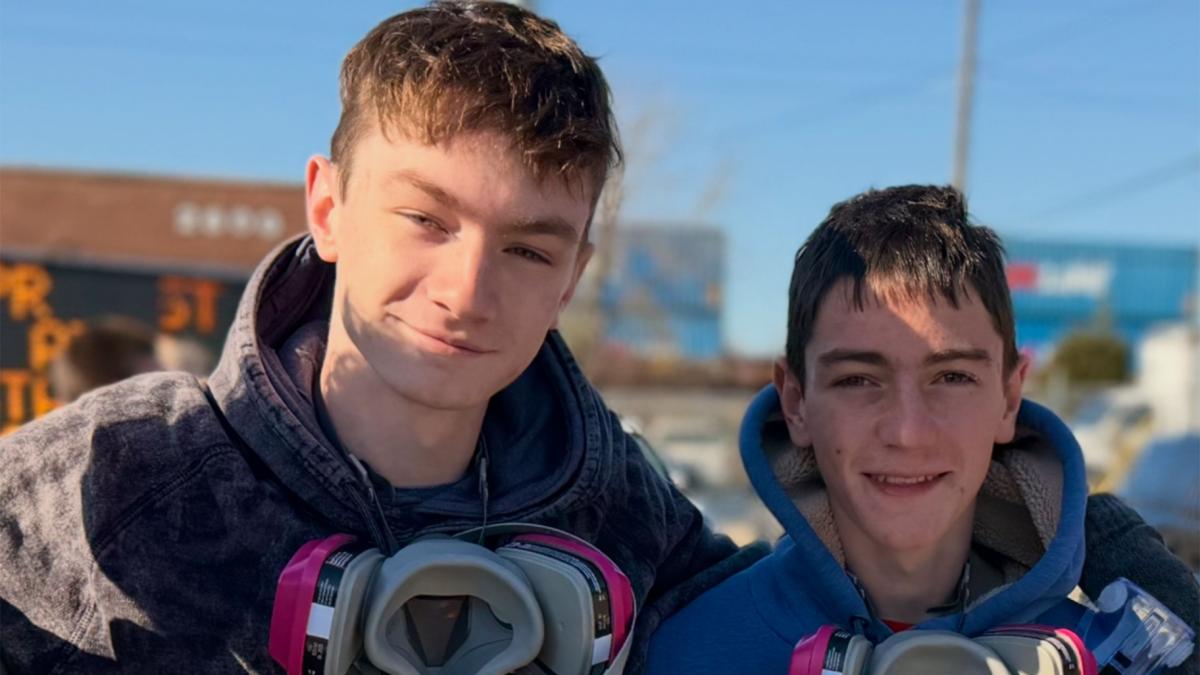 Brothers Ben Luhmann, 17, and Sam Luhmann, 16, pose together outside the ICE detention center in Broadview, Illinois, on Nov. 14, 2025. (Audrey Luhmann via CNN Newsource)