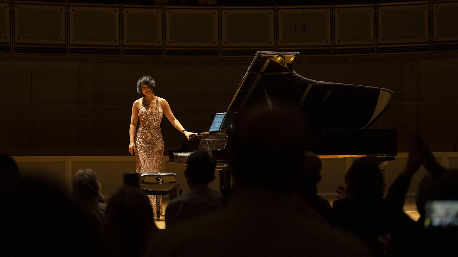 Yuja Wang acknowledges the audience following a program with works by Bach, Beethoven, and Schoenberg April 10, 2022. (Credit: Todd Rosenberg photography)