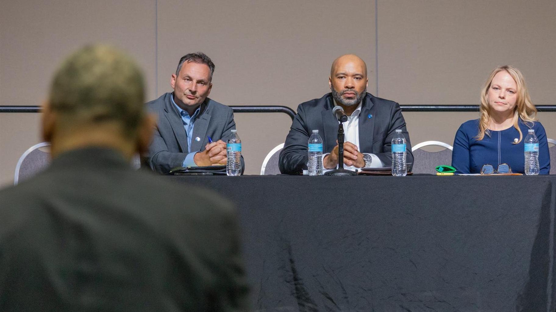 Representatives of Peoples Gas listen to AARP state director Philippe Largent, who requested public hearings to discuss the utility’s proposed rate increase that is pending before the Illinois Commerce Commission. Peoples Gas officials pictured from left to right: Tom Aridas, director of regulatory policy; Torrence Hinton, Peoples Gas’ president; and Polly Eldringhoff, the company’s vice president for operational performance and compliance. (Andrew Adams / Capitol News Illinois)