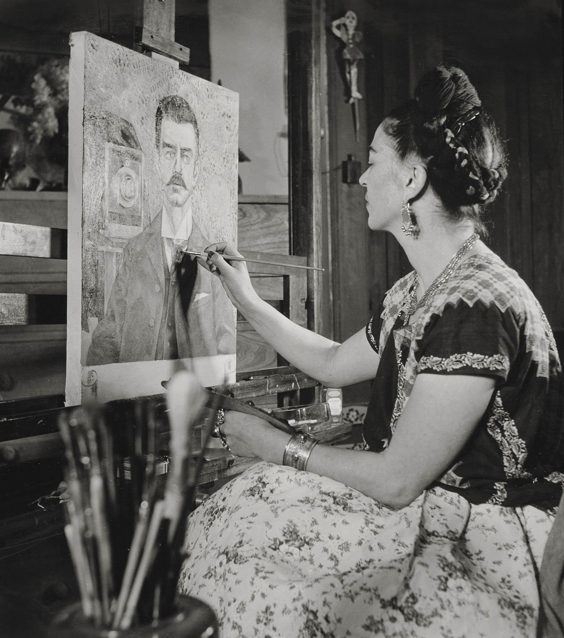 “Frida painting the portrait of her father,” by Gisèle Freund, 1951. (Courtesy of Frida Kahlo & Diego Rivera Archives. Bank of Mexico, Fiduciary in the Diego Rivera and Frida Kahlo Museum Trust).