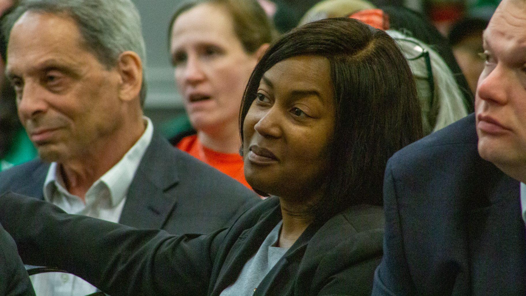 Latoya Hughes, acting director of the Illinois Department of Corrections, sits in the crowd at a public Commission on Government Forecasting and Accountability hearing in Joliet on June 11, 2024. (Dilpreet Raju / Capitol News Illinois)