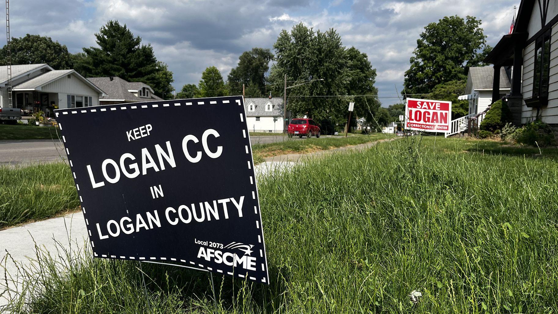 Signs expressing support for Logan Correctional Center’s continued operation dot lawns in Lincoln, where Logan is located. (Hannah Meisel / Capitol News Illinois)
