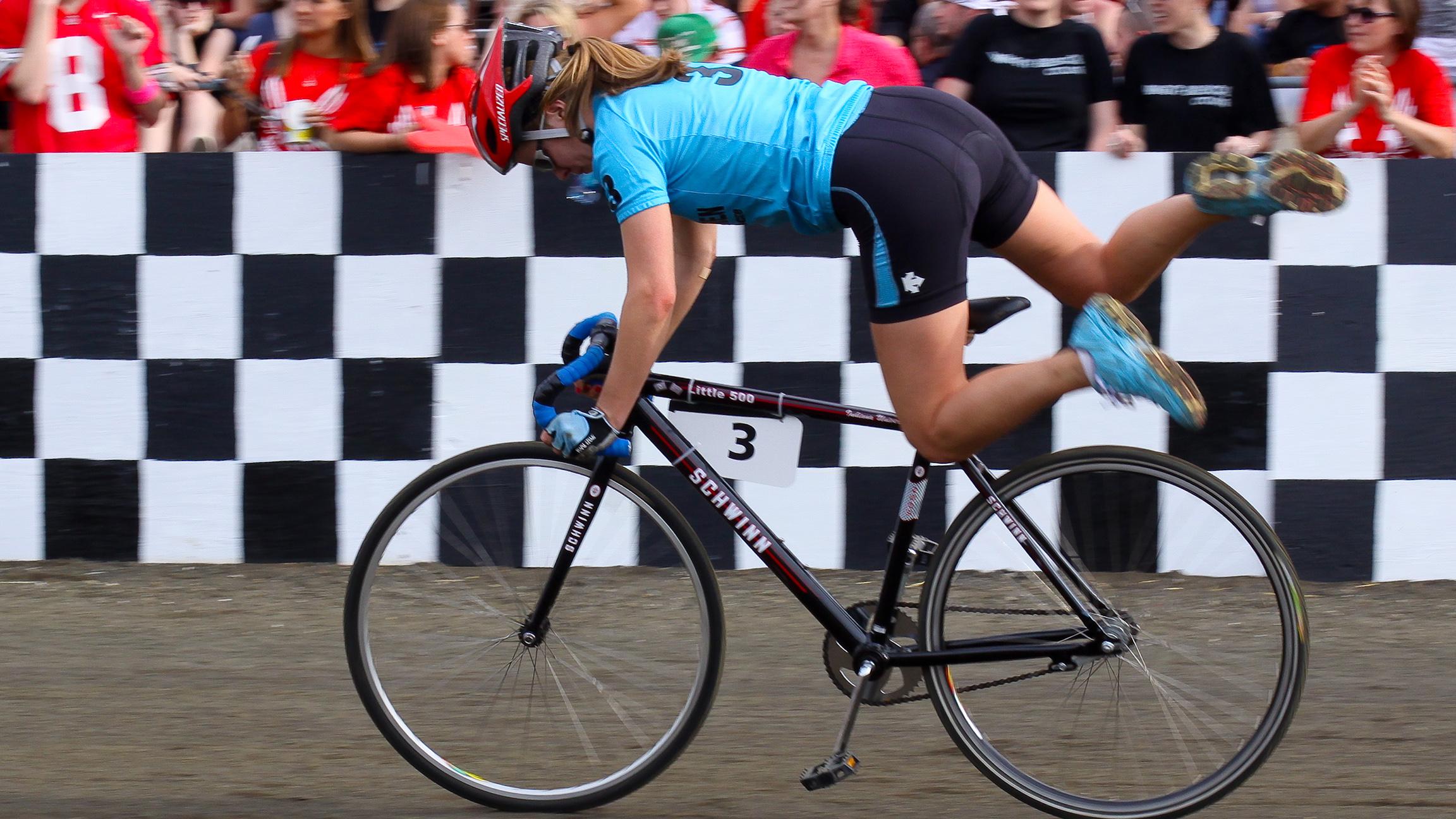 A rider for the Army Women team completes a bike exchange during the Little 500 race on April 24, 2009. (Indiana Public Media / Flickr)