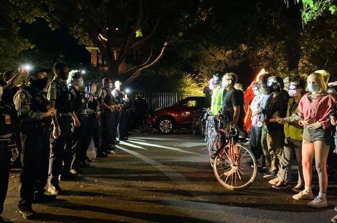 Police and protesters face off on the 4900 block of South Kenwood Avenue on Friday, Sept. 4, 2020. (Grace Del Vecchio / WTTW News)