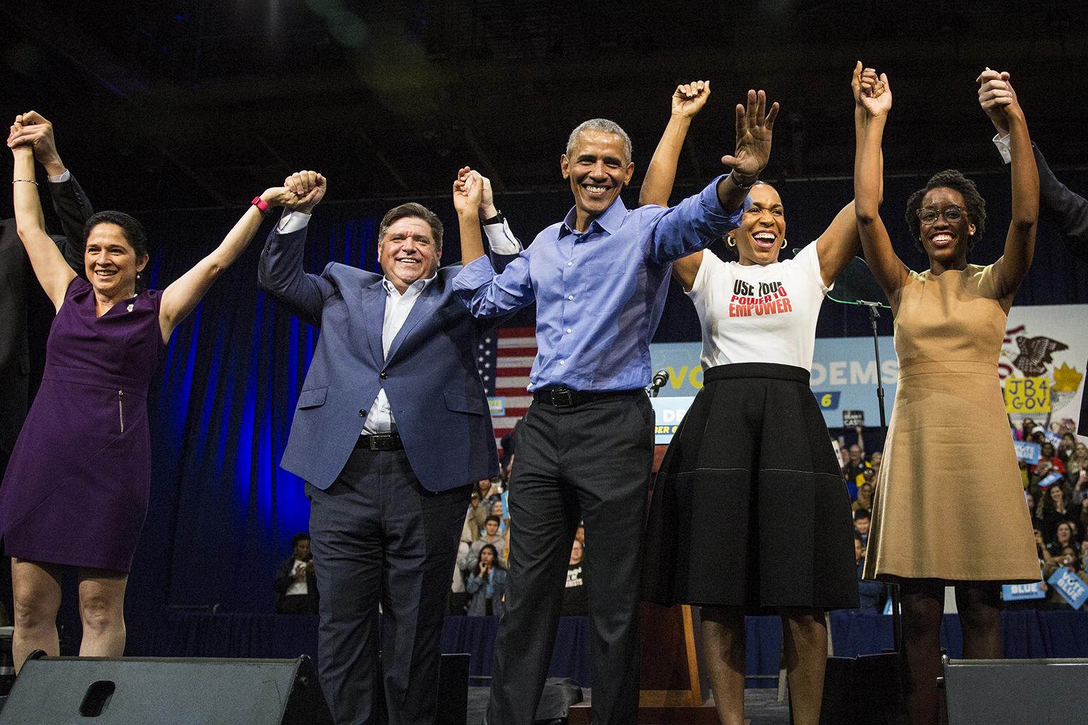 Former President Barack Obama, center, headlines a rally and appears alongside, from left to right, Illinois Comptroller Susana Mendoza, gubernatorial candidate J.B. Pritzker, lieutenant governor candidate Juliana Stratton and congressional candidate Lauren Underwood on Sunday, Nov. 4, 2018 at the University of Illinois at Chicago. (Ashlee Rezin / Chicago Sun-Times via AP)