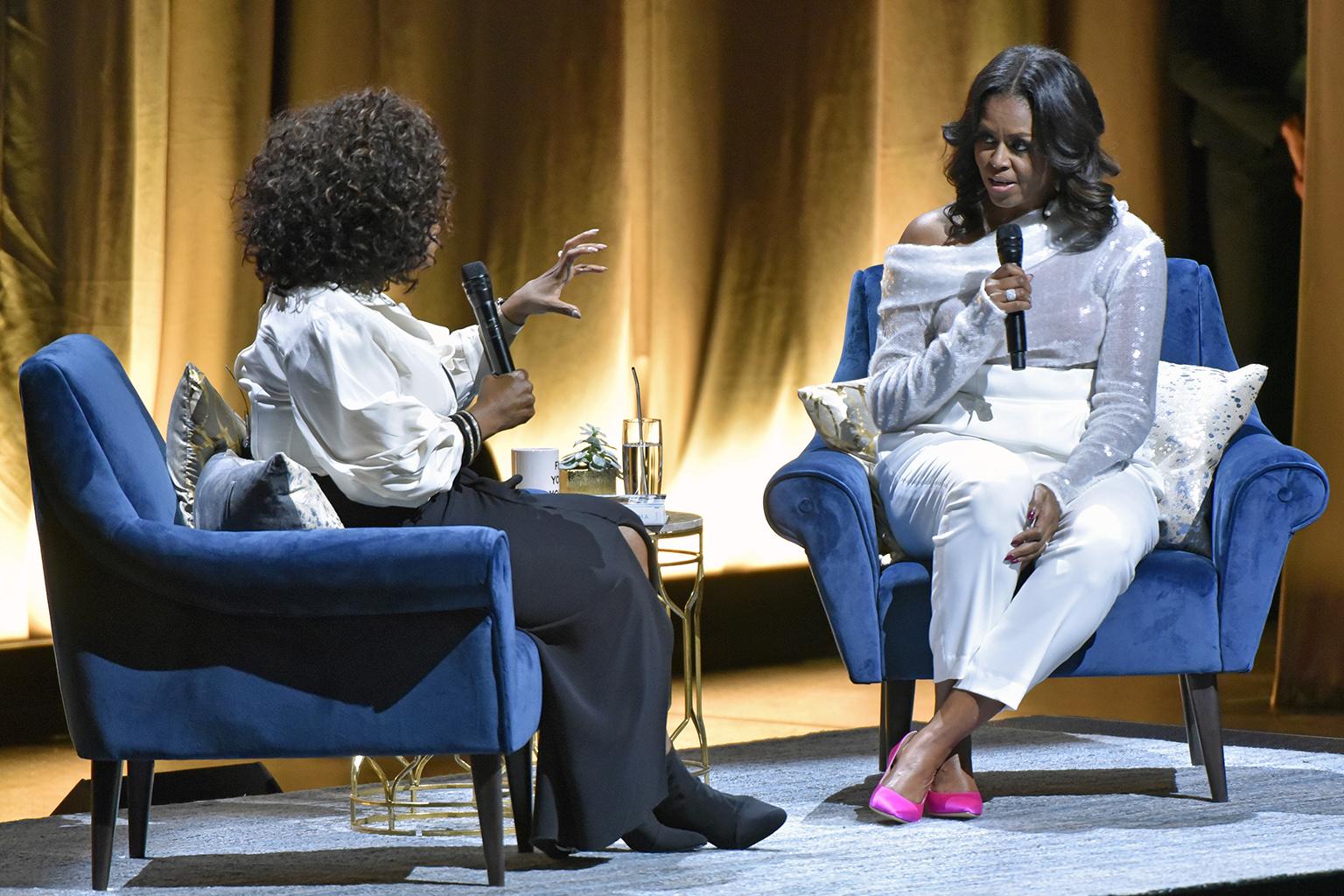 Michelle Obama, right, discusses her new book with Oprah Winfrey during an intimate conversation to promote “Becoming” at the United Center on Tuesday, Nov. 13, 2018. (Photo by Rob Grabowski / Invision / AP)