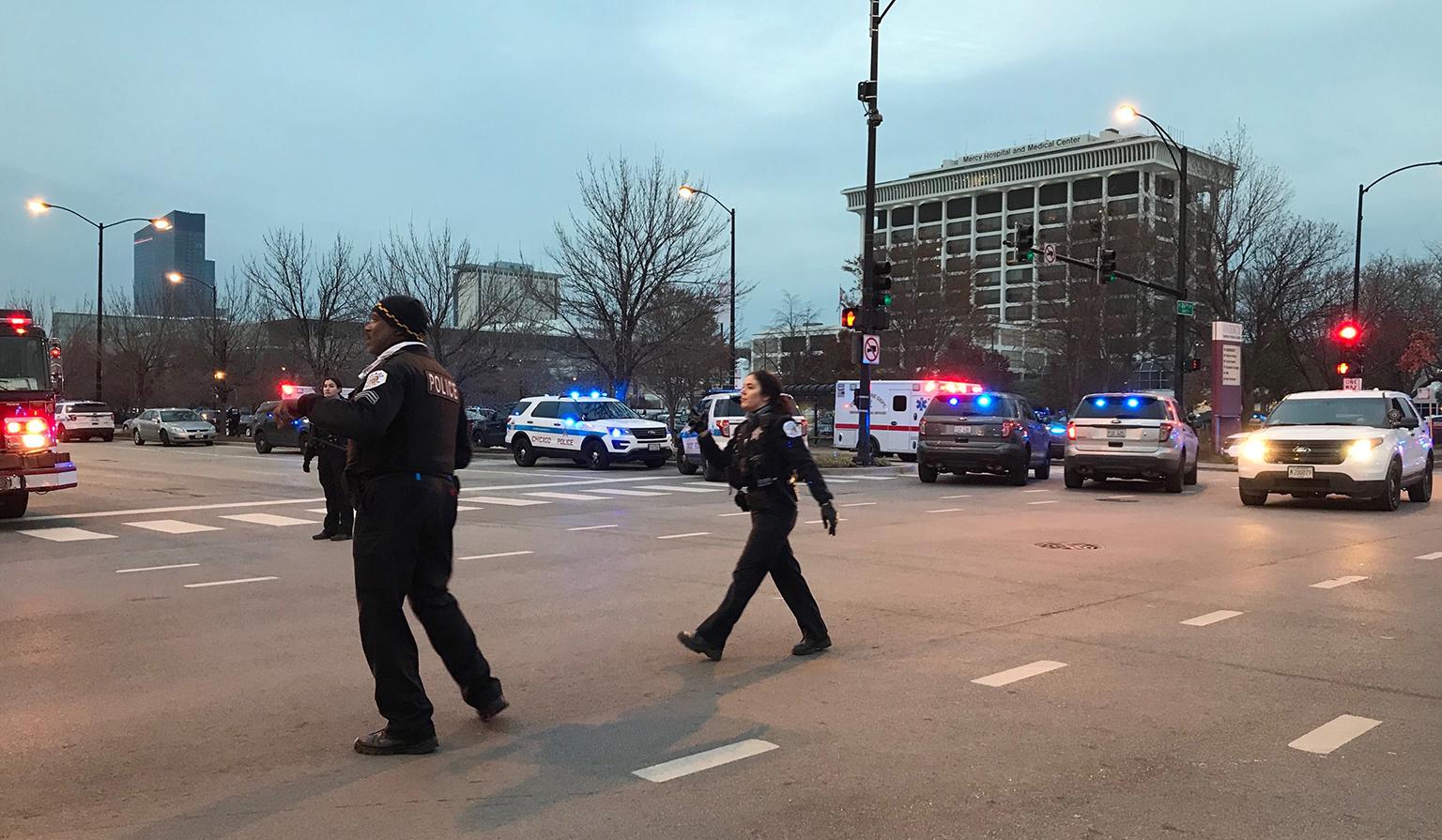 Chicago police officers walk outside Mercy Hospital on the city’s Near South Side where authorities say a shooting at the hospital has wounded multiple people, including a suspect and a police officer on Monday, Nov. 19, 2018. (AP Photo / Amanda Seitz)