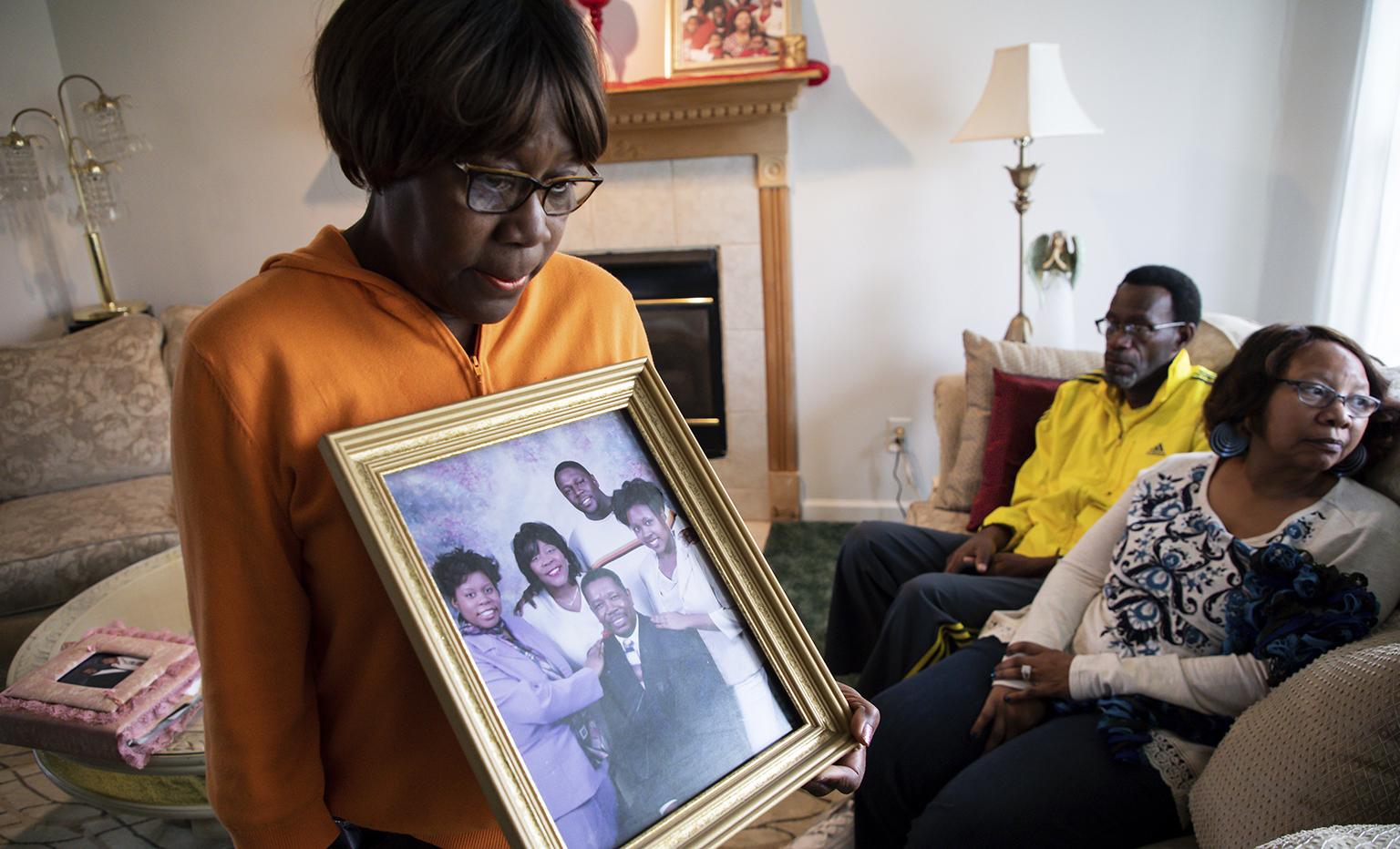 Glenda O'Neal, mother of Dr. Tamara O'Neal, shows a photo of her family at their home in LaPorte, Ind., Tuesday, Nov. 20, 2018. Dr. O’Neal was one of the three people fatally shot Monday at Mercy Hospital. (Zbigniew Bzdak / Chicago Tribune via AP)