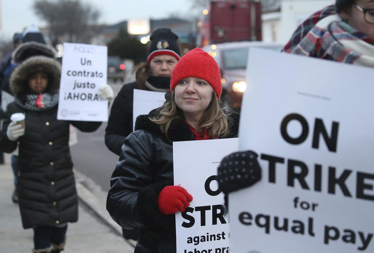 Charter school teachers including Vanessa Cerf-Nikolakakis, center, of Torres Elementary School, and other supporters walk the picket line outside the Acero's Zizumbo Elementary Charter School, Tuesday, Dec. 4, 2018. (Antonio Perez / Chicago Tribune via AP)