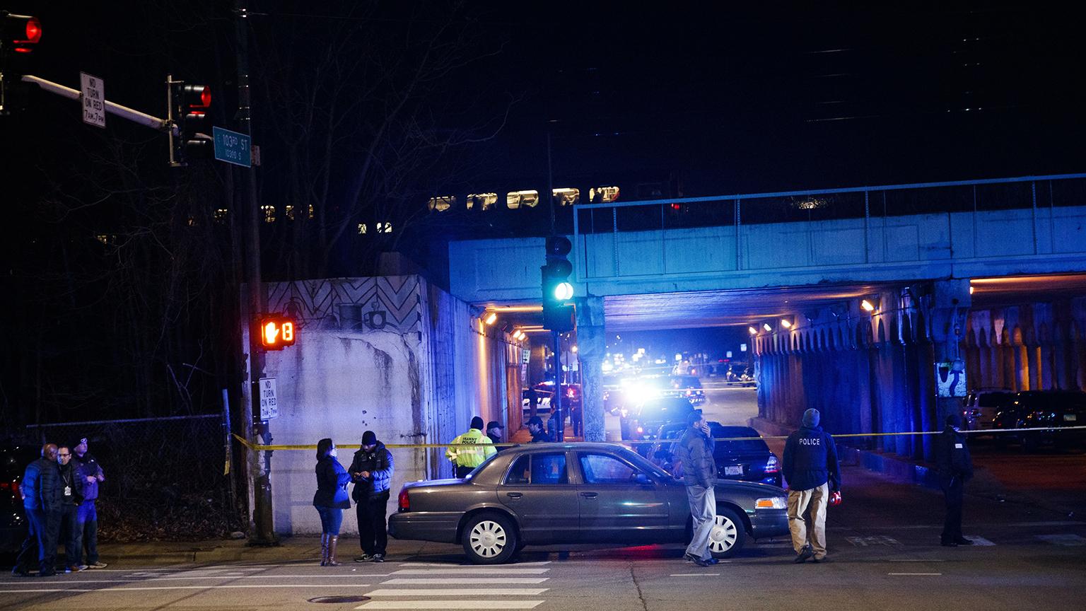 Police investigate the scene where two officers were killed after they were struck by a South Shore train near 103rd Street and Dauphin Avenue on Monday, Dec. 17, 2018. (Armando L. Sanchez / Chicago Tribune via AP)