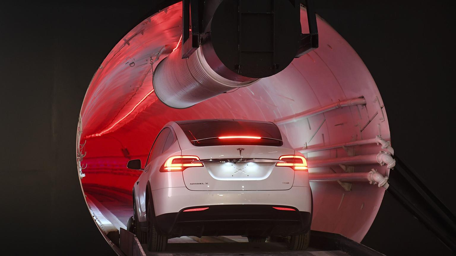 A modified Tesla Model X drives in the tunnel entrance before an unveiling event on Tuesday, Dec. 18, 2018 for the Boring Co. Hawthorne test tunnel in Hawthorne, Calif. (Robyn Beck / Pool Photo via AP)