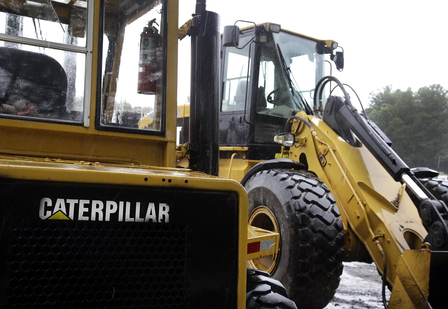 In this Monday, July 24, 2017 file photo, Caterpillar loaders are parked in Middleton, Massachusetts.  (AP Photo / Elise Amendola) 