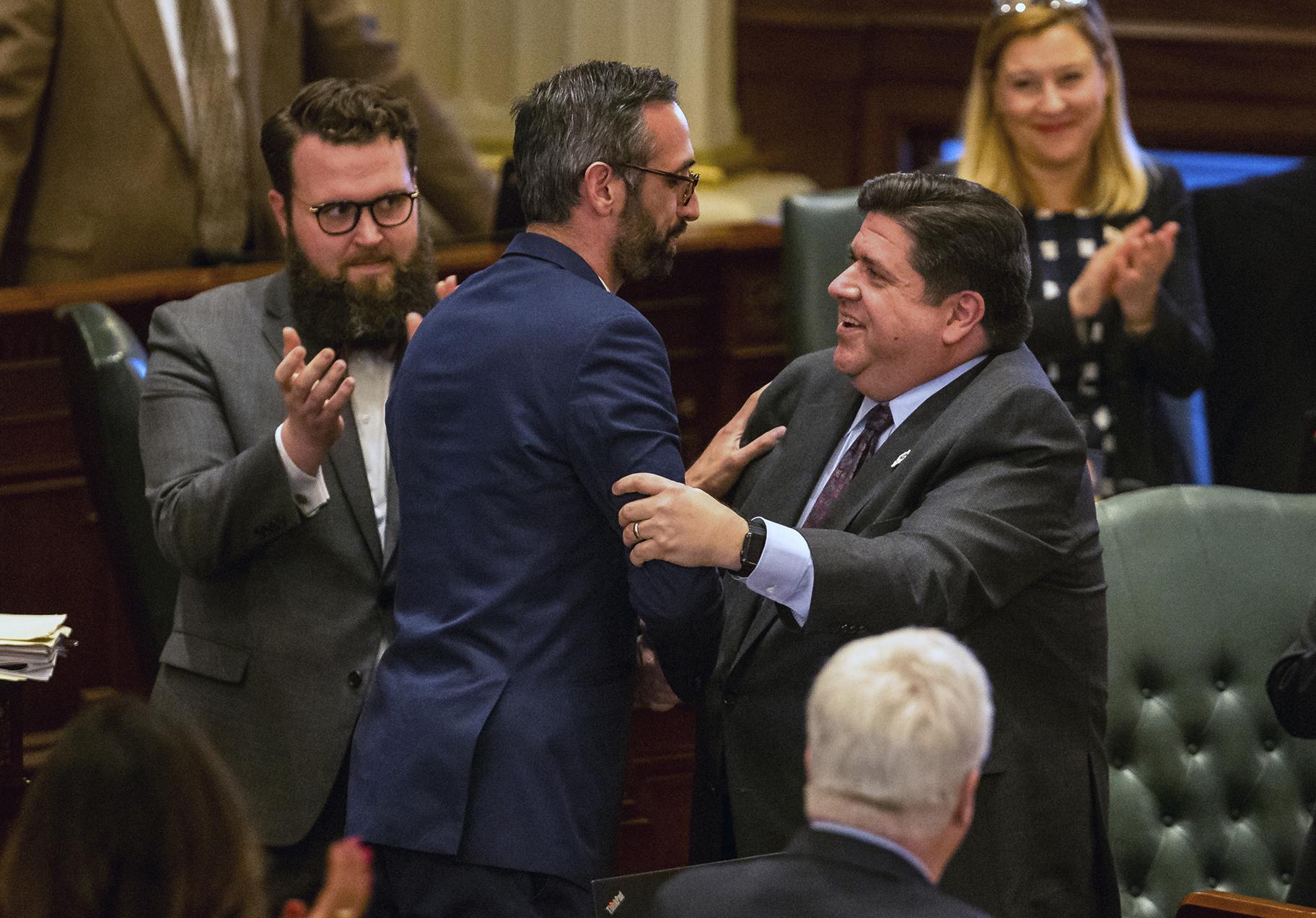 Gov. J.B. Pritzker, right, congratulates state Rep. Will Guzzardi, D-Chicago, left, on the House floor at the Illinois State Capitol on Thursday, Feb. 14, 2019. (Justin L. Fowler / The State Journal-Register via AP)
