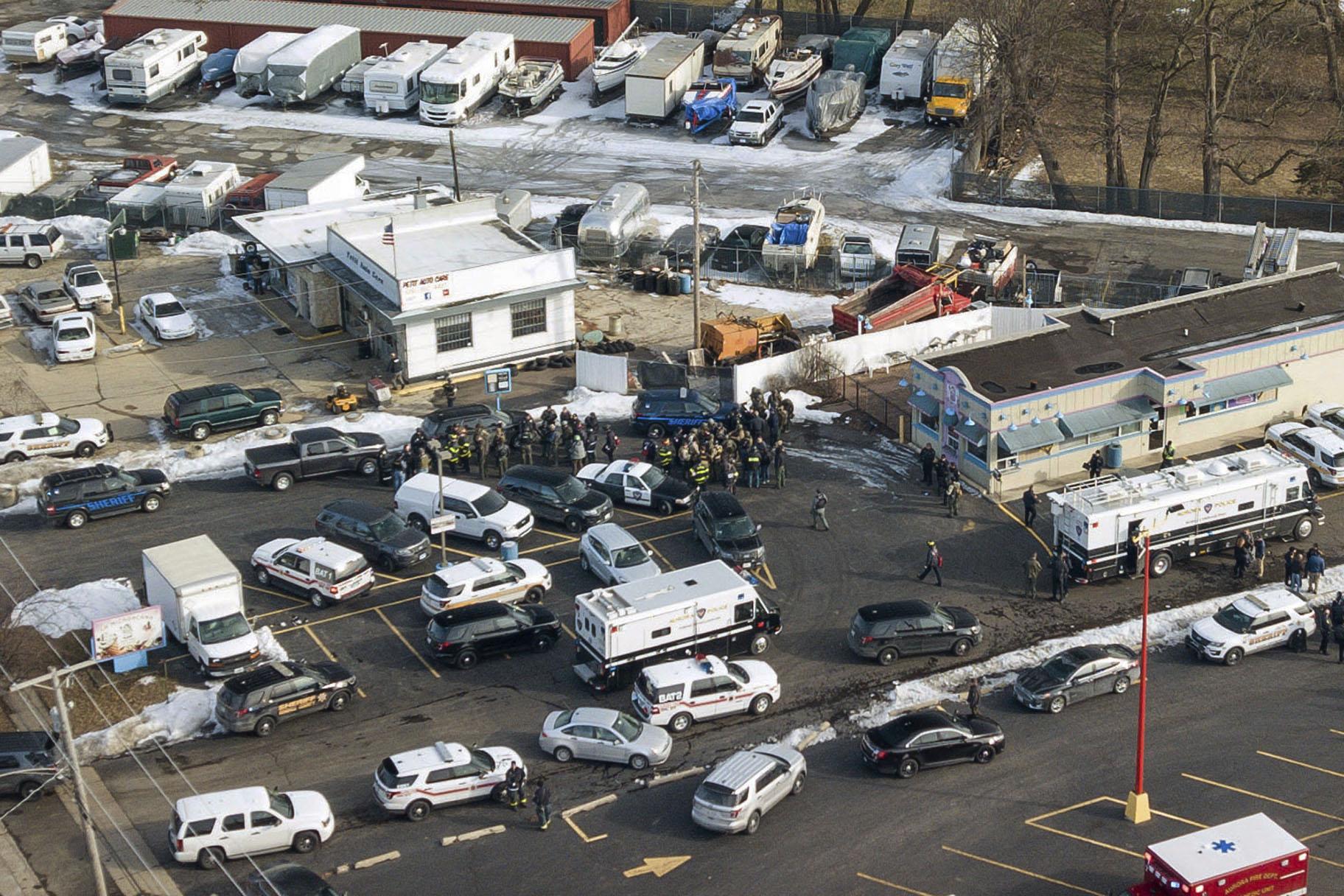 Law enforcement personnel gather near the scene of a shooting at an industrial park in Aurora, Illinois, on Friday, Feb. 15, 2019. (Bev Horne / Daily Herald via AP)