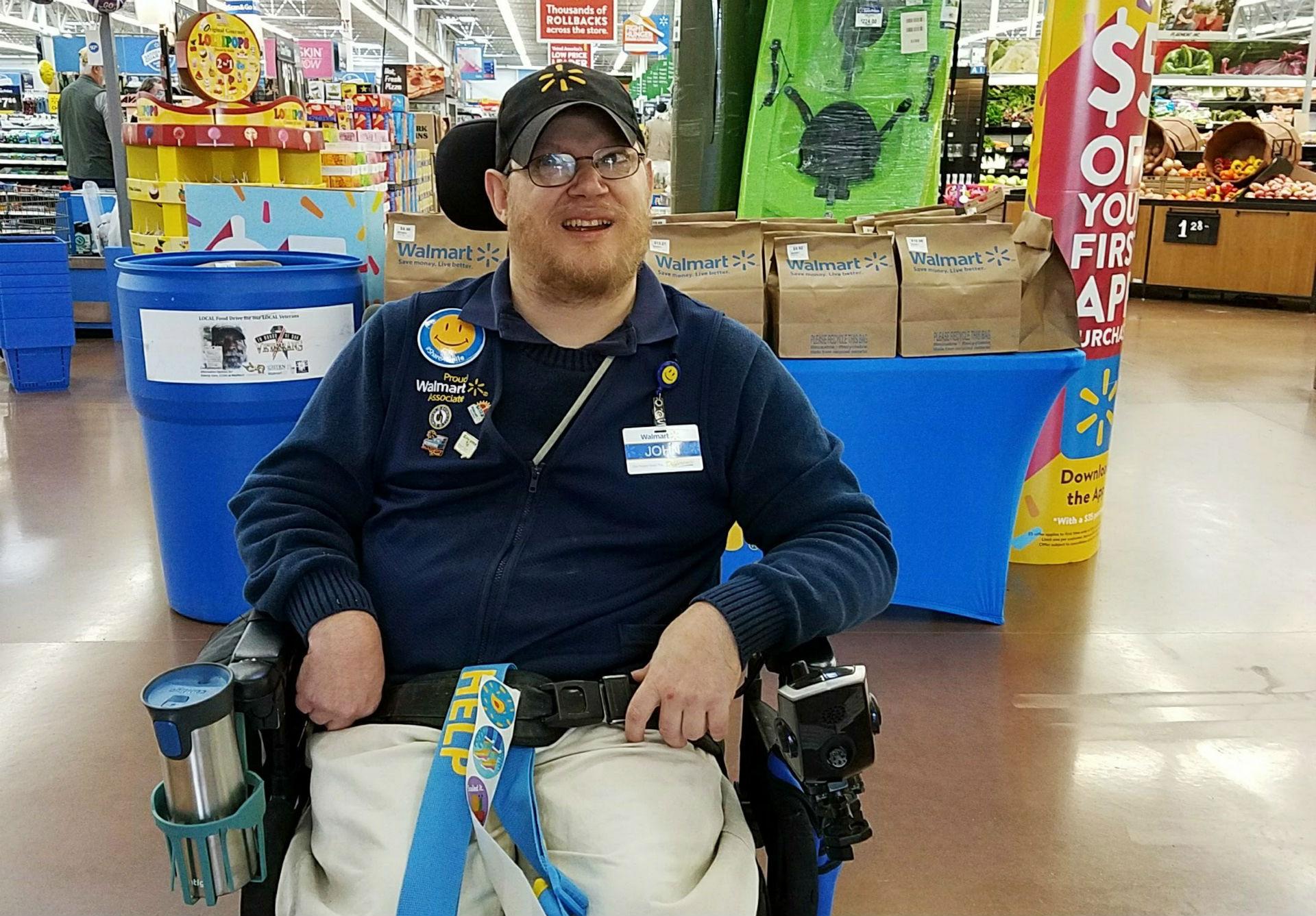 In this April 21, 2018 photo provided by Rachel Wasser, Walmart greeter John Combs works at a Walmart store in Vancouver, Washington. (Rachel Wasser via AP)