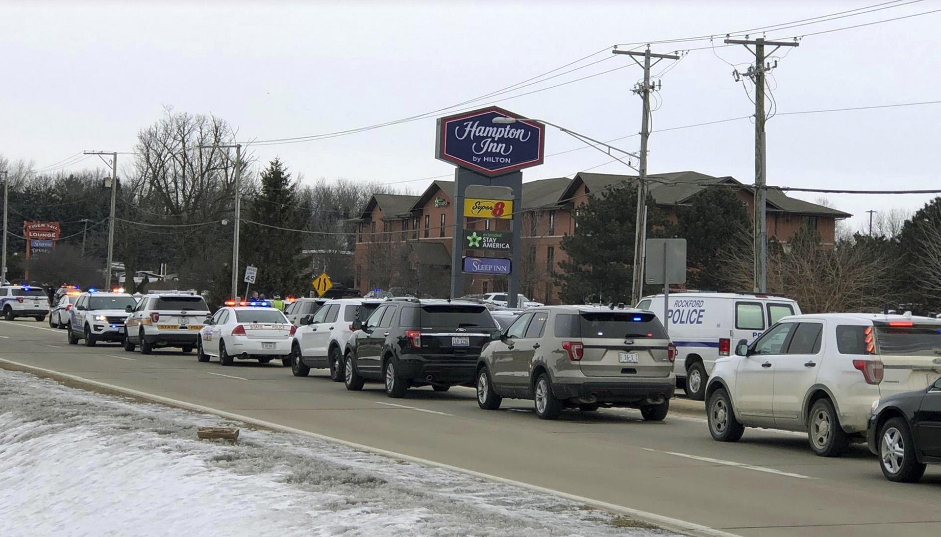 Area law enforcement vehicles gather near the scene of a shooting in Rockford, Ill., Thursday, March 7, 2019. (Ken DeCoster / Rockford Register Star via AP)