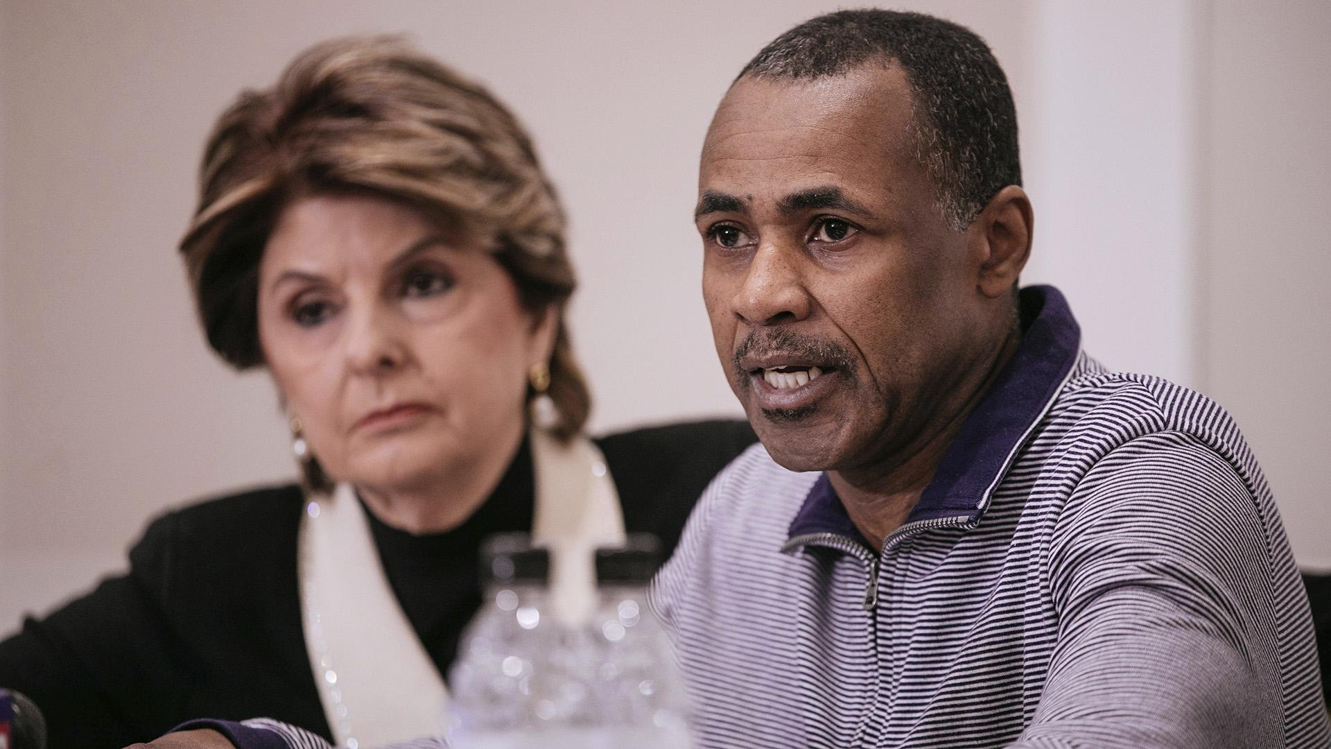 Gary Dennis, seated with lawyer Gloria Allred, speaks during a Sunday, March 10, 2019 press conference announcing a videotape said to present further evidence of wrongdoing by recording artist R. Kelly. Dennis said the tape, which he found at his home in Pennsylvania, shows R. Kelly sexually abusing more than one underage girl. (AP Photo / Kevin Hagen)