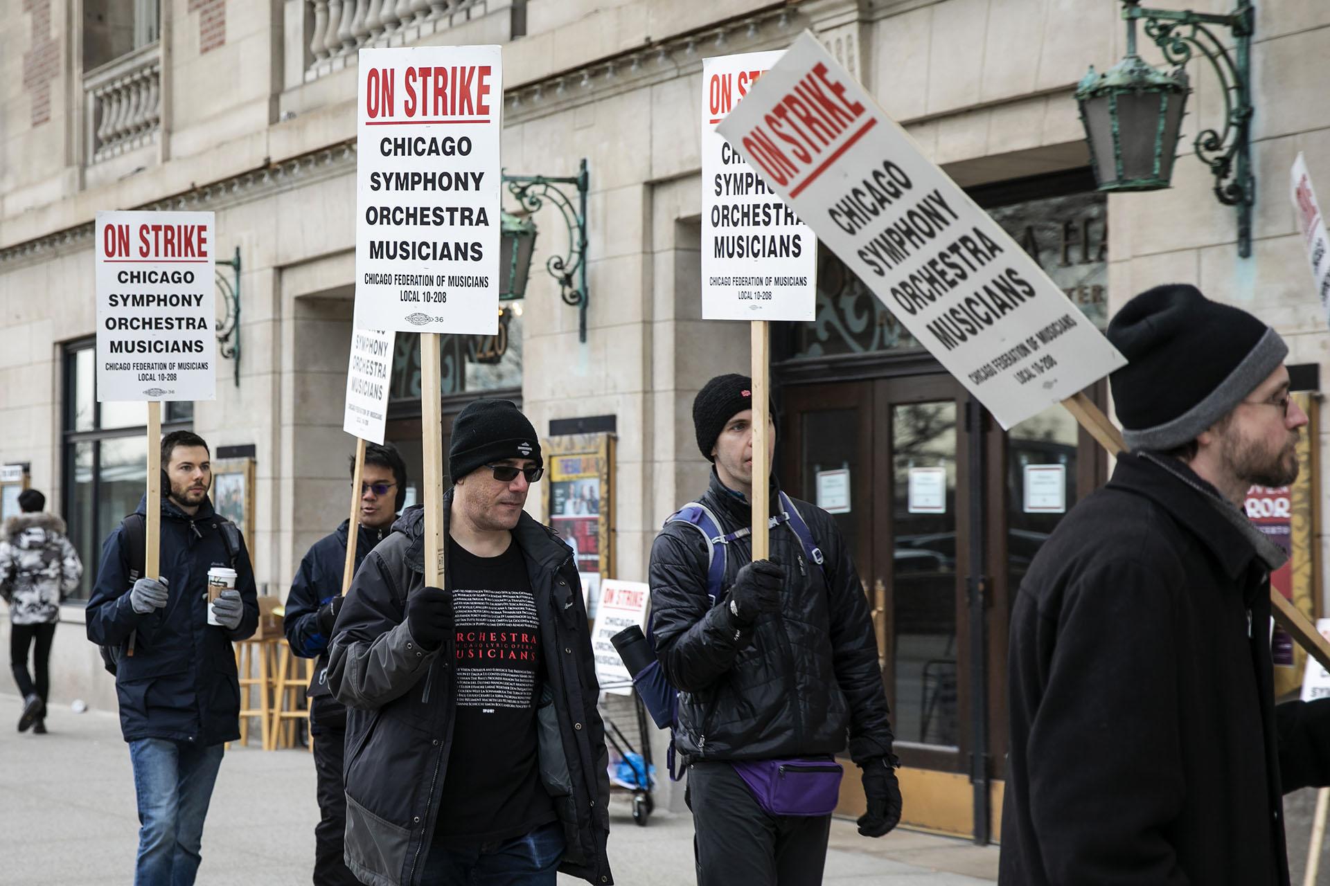 Musicians of the Chicago Symphony Orchestra go on strike and walk the picket line outside the doors of Orchestra Hall on Michigan Avenue, Monday, March 11, 2019. (Ashlee Rezin / Chicago Sun-Times via AP)