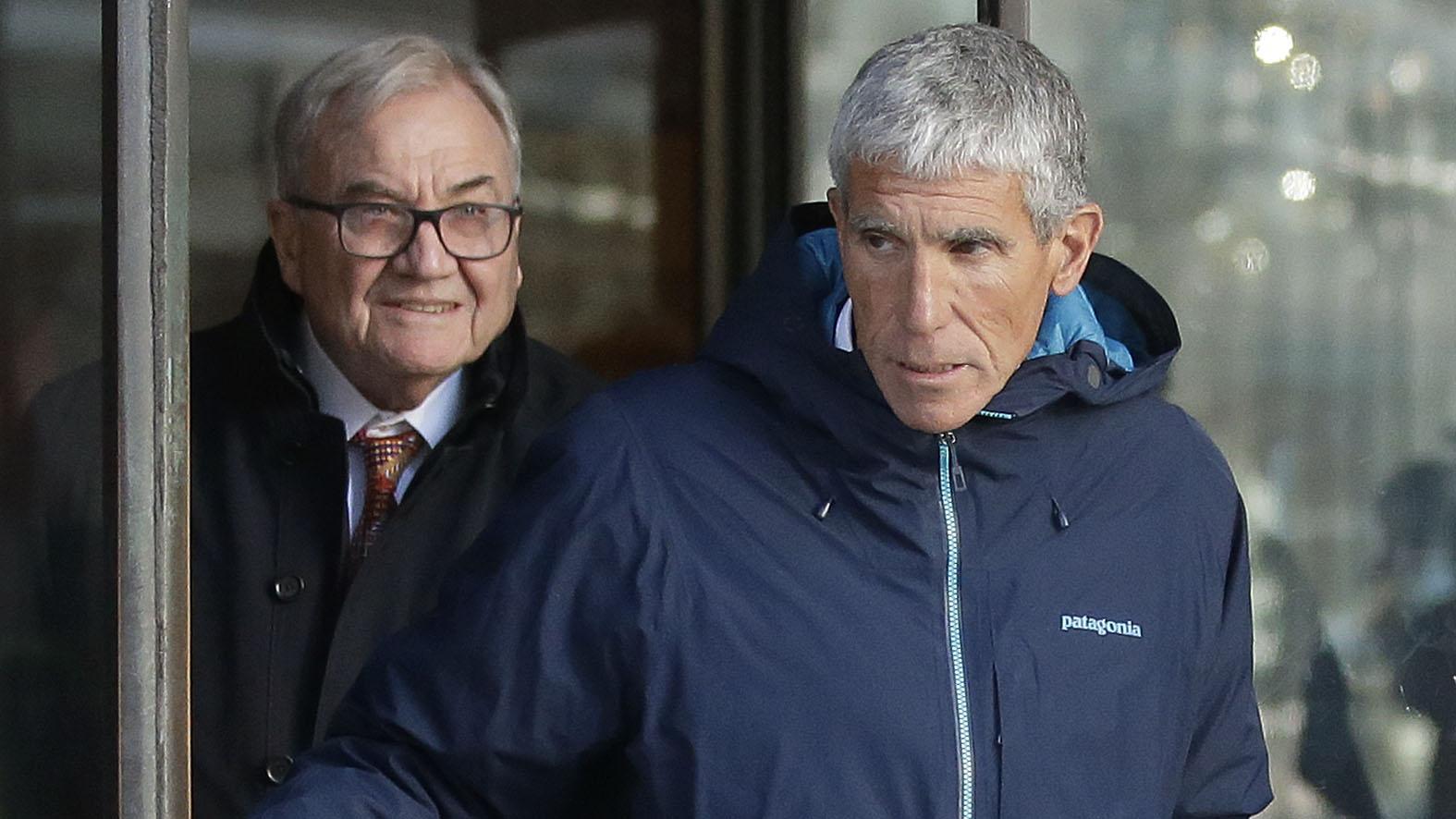 William “Rick” Singer, front, founder of the Edge College & Career Network, exits federal court in Boston on Tuesday, March 12, 2019, after he pleaded guilty to charges in a nationwide college admissions bribery scandal. (AP Photo / Steven Senne)