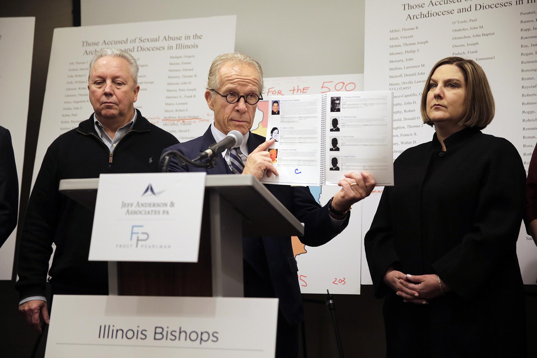 Attorney Jeff Anderson speaks as Joe Iacono, left, and Cindy Yesko listen during a news conference in Chicago on Wednesday, March 20, 2019. Advocates for clergy abuse victims say their list of 395 priests or lay people in Illinois who have been publicly accused of sexually abusing children is far more extensive than the names already released by the state’s six dioceses. (AP Photo / Kiichiro Sato)