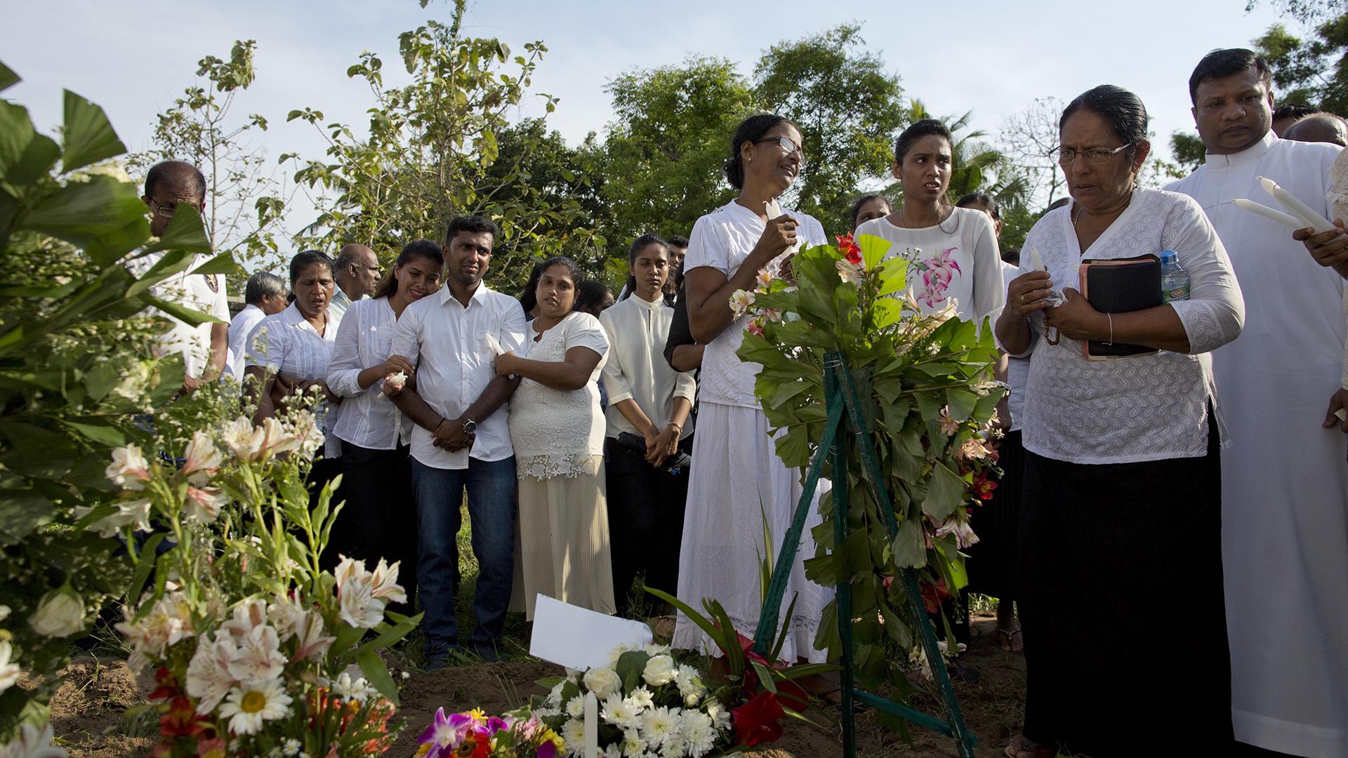 Family members mourn Tuesday, April 23, 2019 at the burial of 7-year-old Dhulodh Anthony, a victim of an Easter Sunday bomb blast, at Methodist cemetery in Negombo, Sri Lanka. (AP Photo / Gemunu Amarasinghe)