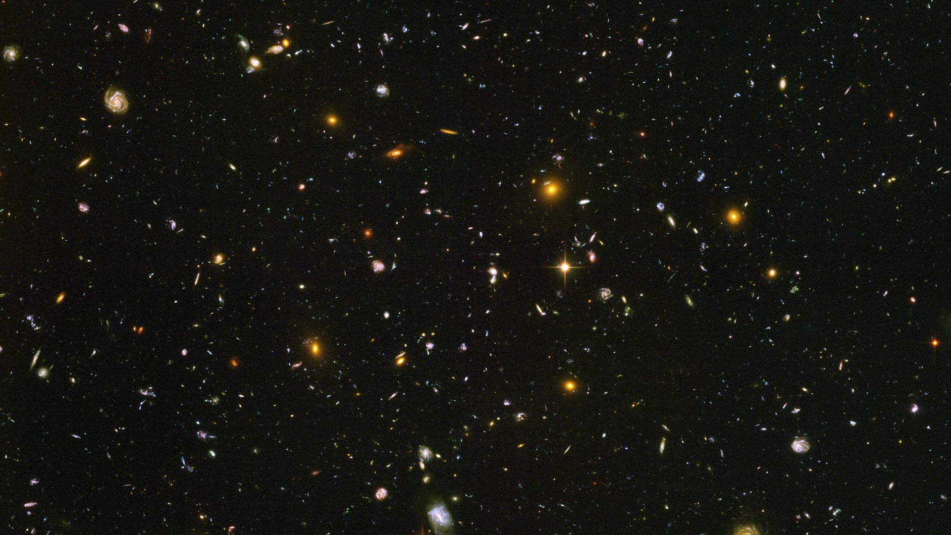 This image made from a composite of September 2003 - January 2004 photos captured by the NASA/ESA Hubble Space Telescope shows nearly 10,000 galaxies in the deepest visible-light image of the cosmos, cutting across billions of light-years. (NASA, ESA, S. Beckwith (STScI), HUDF Team via AP)