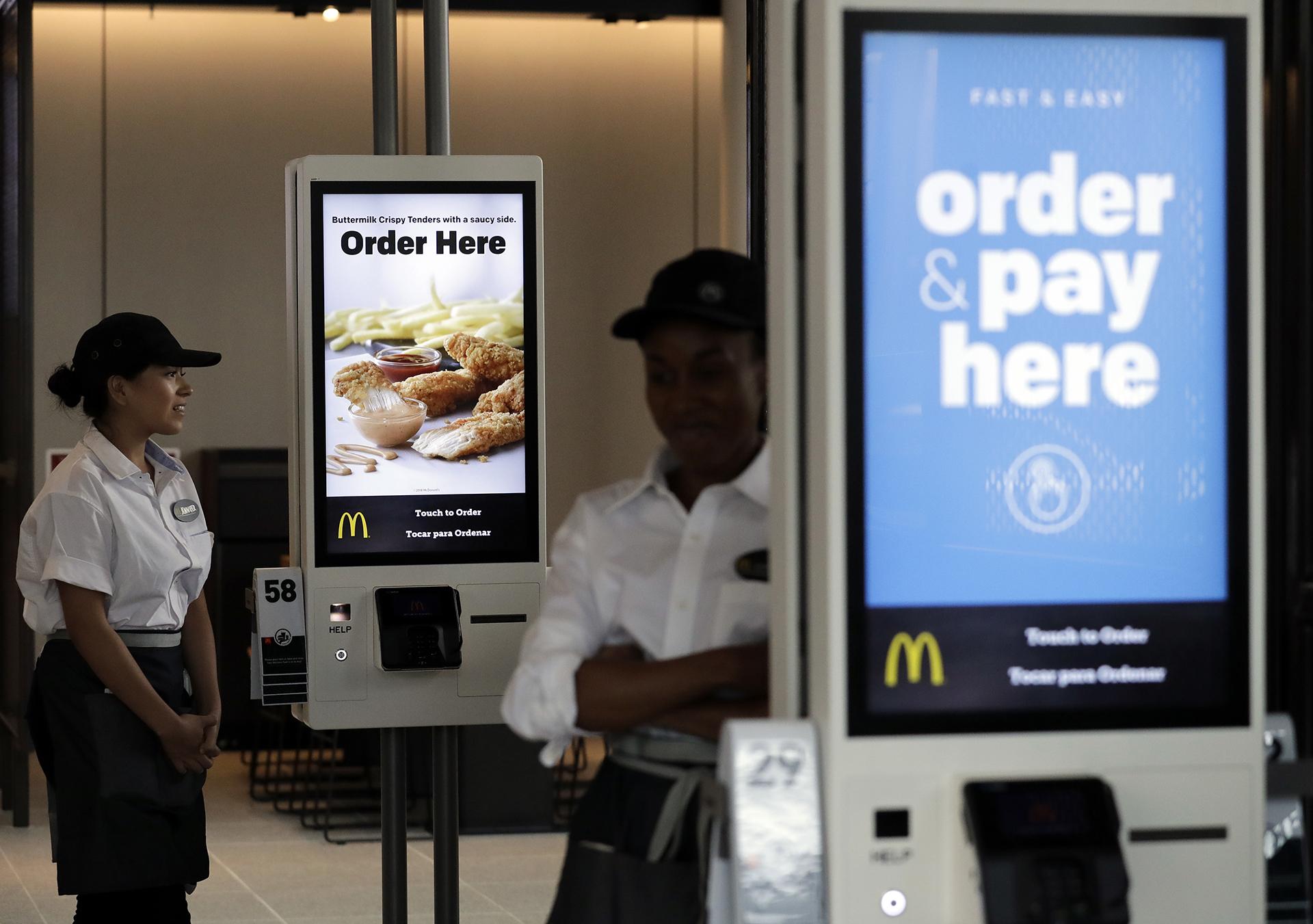 In this Aug. 8, 2018, file photo employees stand in McDonald’s Chicago flagship restaurant. (AP Photo / Nam Y. Huh, File)