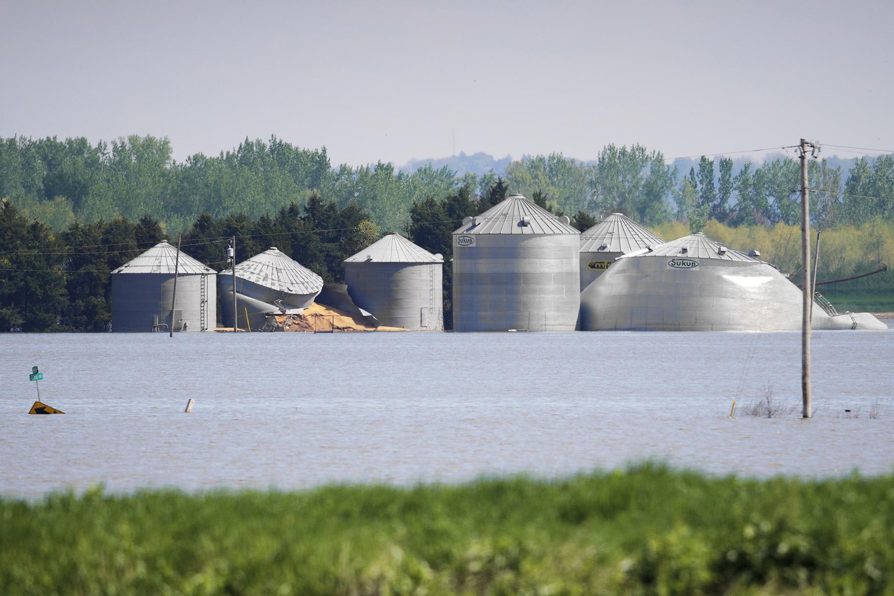 In this May 10, 2019 photo, grain bins belonging to Brett Adams are surrounded by flood waters, in Peru, Neb. (AP Photo / Nati Harnik)