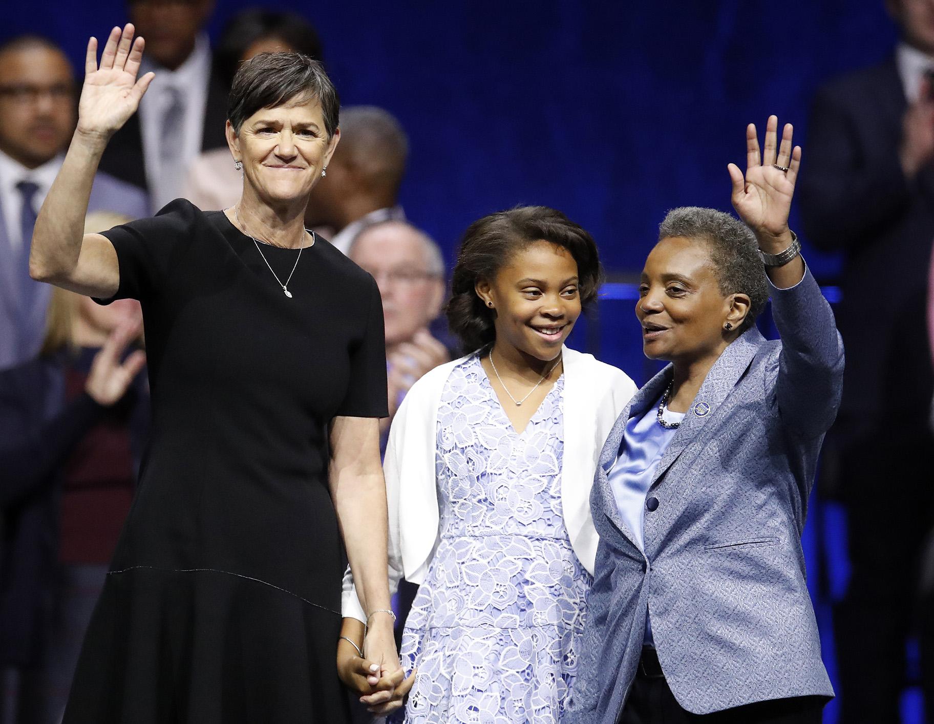 Chicago Mayor Lori Lightfoot, right, is joined on stage with her spouse Amy Eshleman, left, and her daughter Vivian during her inauguration ceremony on Monday, May 20, 2019. (AP Photo / Jim Young)