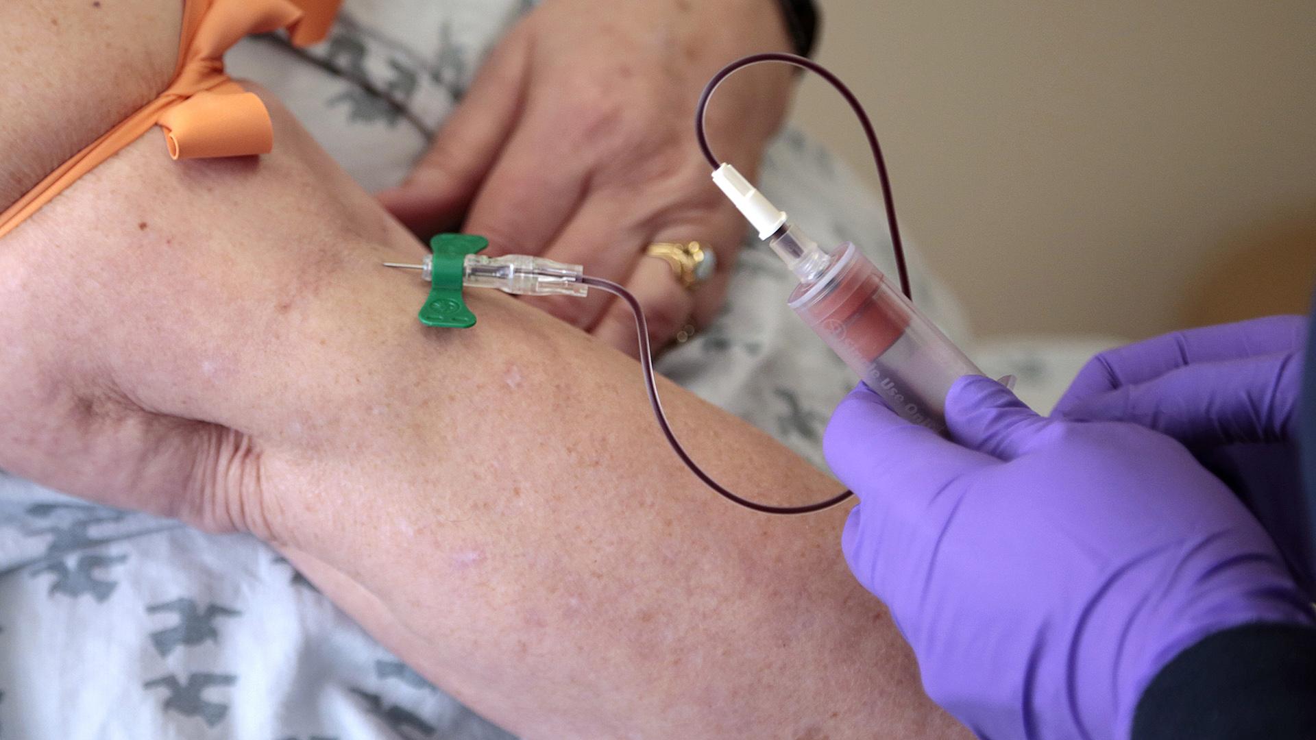 In this Tuesday, April 28, 2015 file photo, a patient has her blood drawn at a hospital in Philadelphia to monitor her cancer treatment. Companies are trying to develop blood tests that can look for signs of many types of cancer at once. (AP Photo / Jacqueline Larma, File)