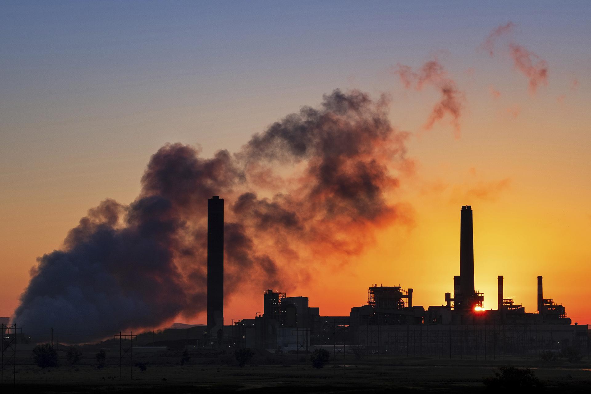 In this July 27, 2018, file photo, the Dave Johnson coal-fired power plant is silhouetted against the morning sun in Glenrock, Wyoming. (AP Photo / J. David Ake, File)