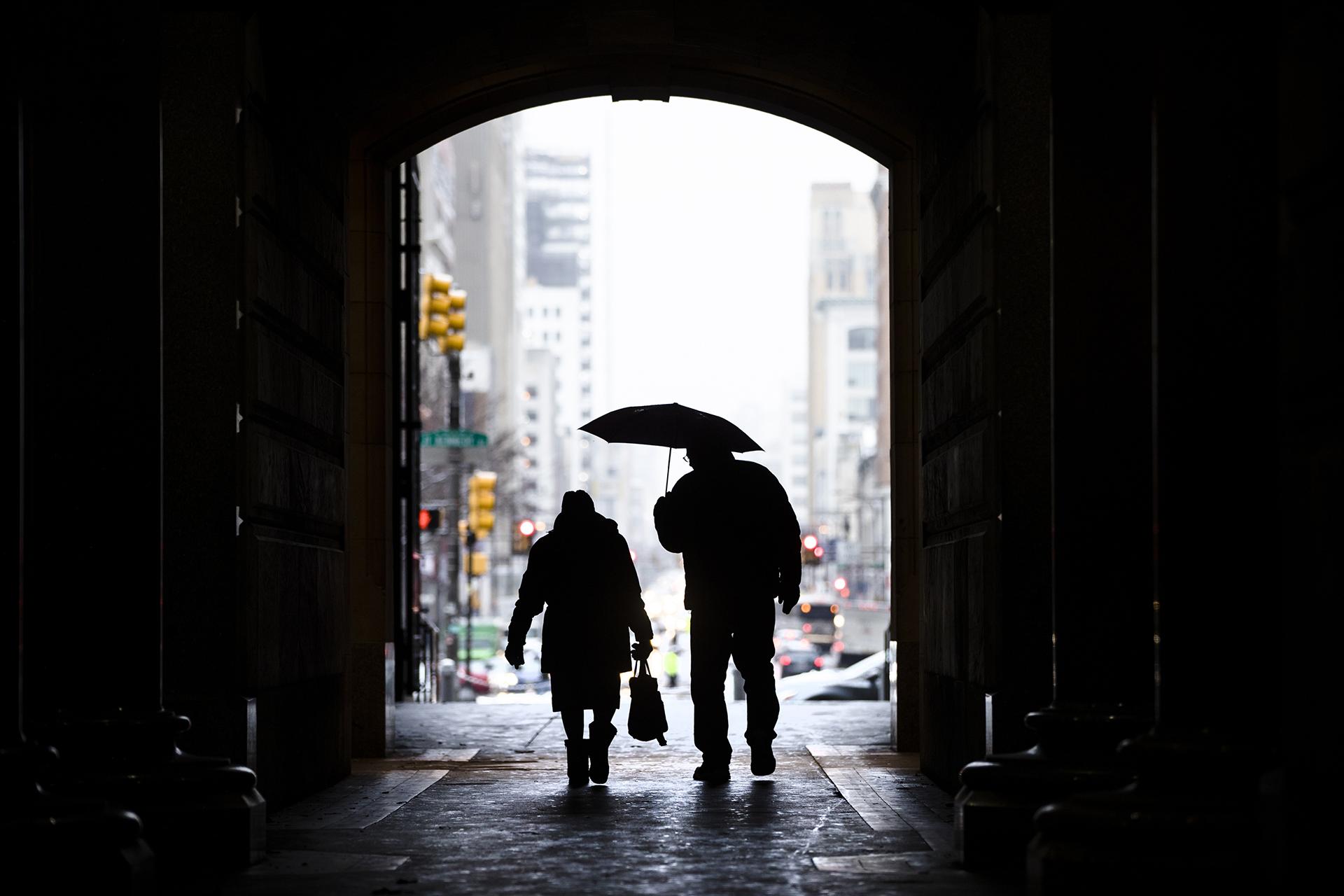 In this Feb. 12, 2019, file photo pedestrians pass beneath City Hall in Philadelphia. (AP Photo / Matt Rourke, File)
