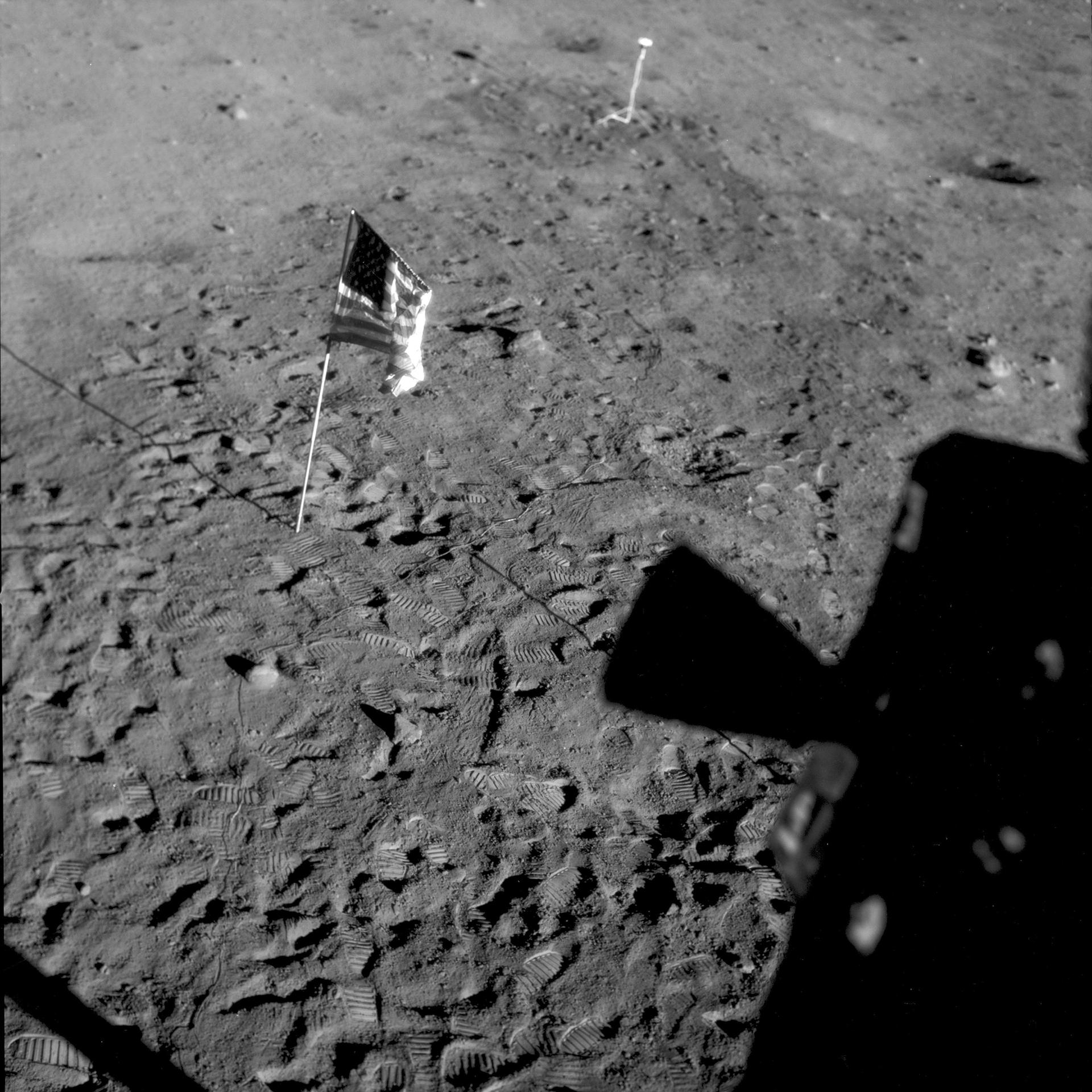 This July 21, 1969 photo made available by NASA shows the U.S. flag planted at Tranquility Base on the surface of the moon, and a silhouette of a thruster at right, seen from a window in the Lunar Module. (NASA via AP)