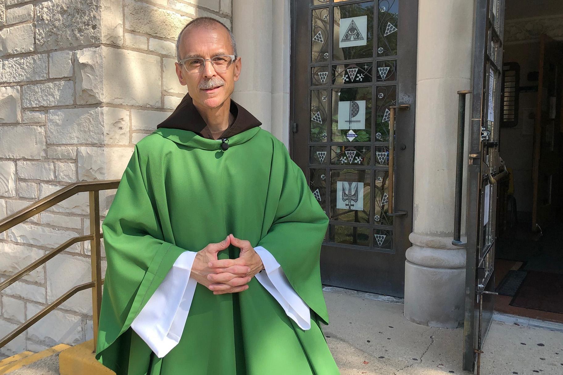 Rev. John Celichowski poses outside of the Saint Clare of Montefalco Catholic Church in Chicago. (AP Photo / Sophia Tareen)